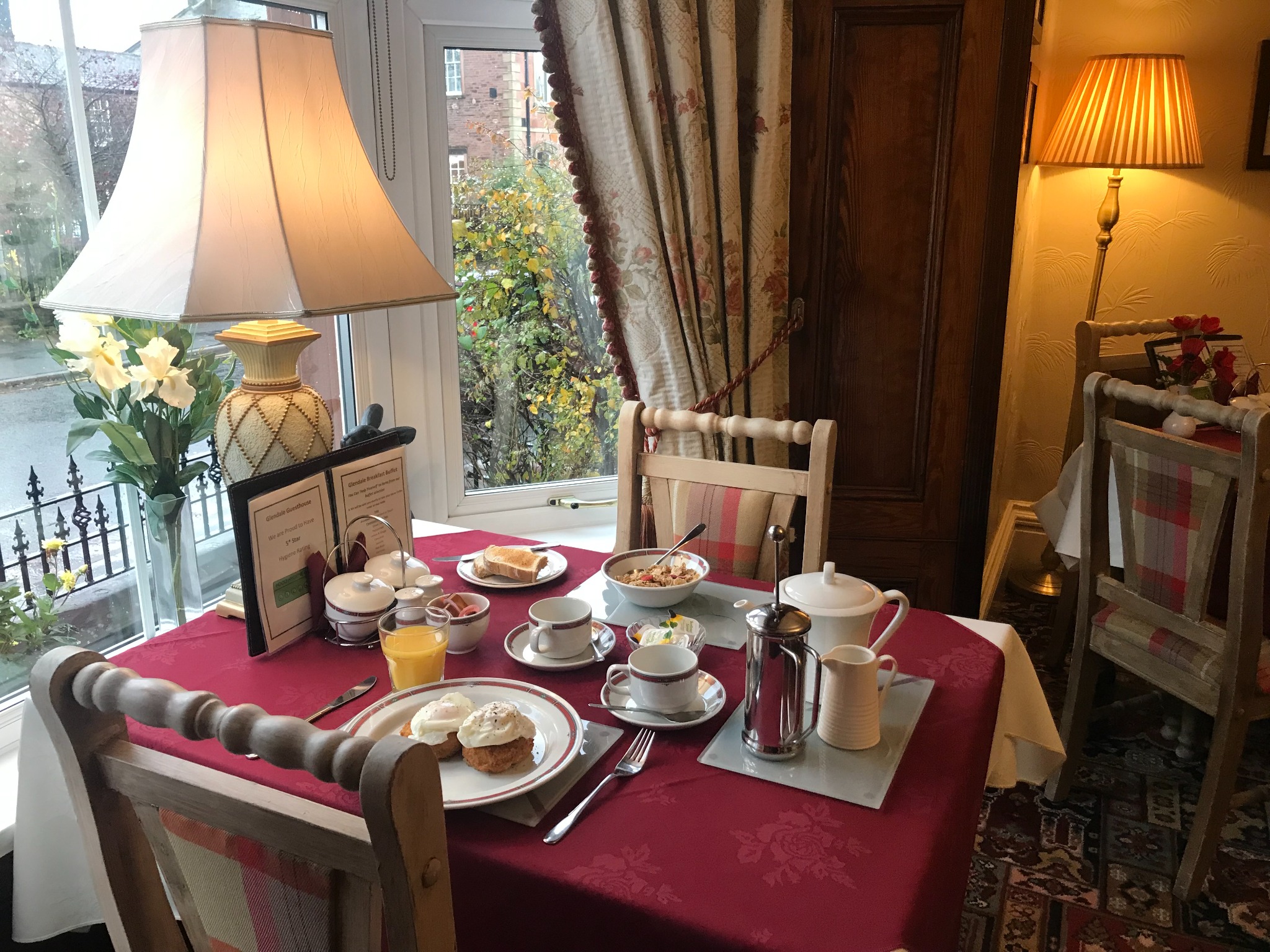 Breakfast table set beside the window at Glendale Guesthouse